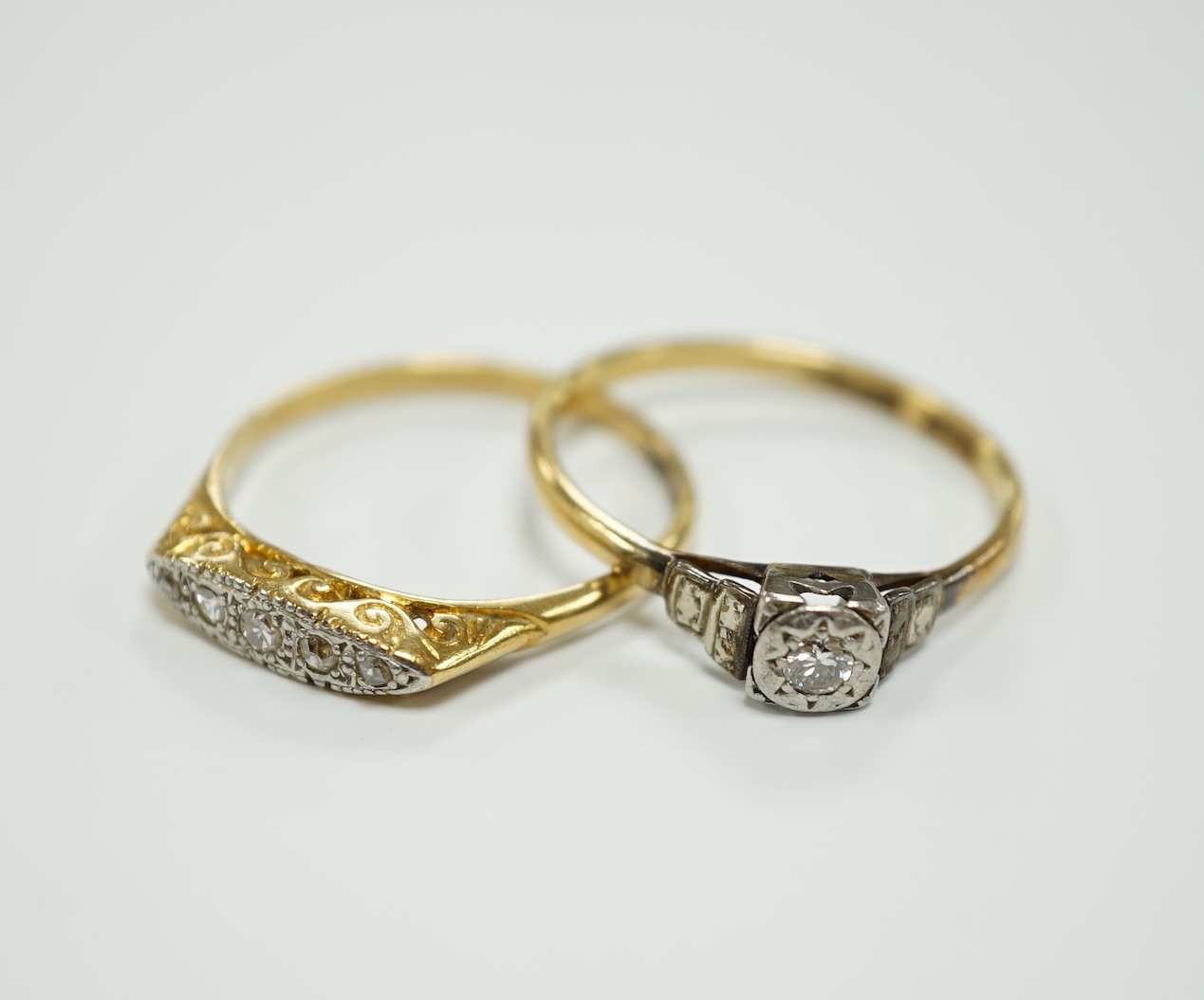 Two early to mid 20th century 18ct, plat and diamond set rings, including graduated five stone, gross weight 7.8 grams.